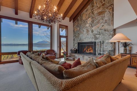 spacious living room with lake views and hearth stone fireplace