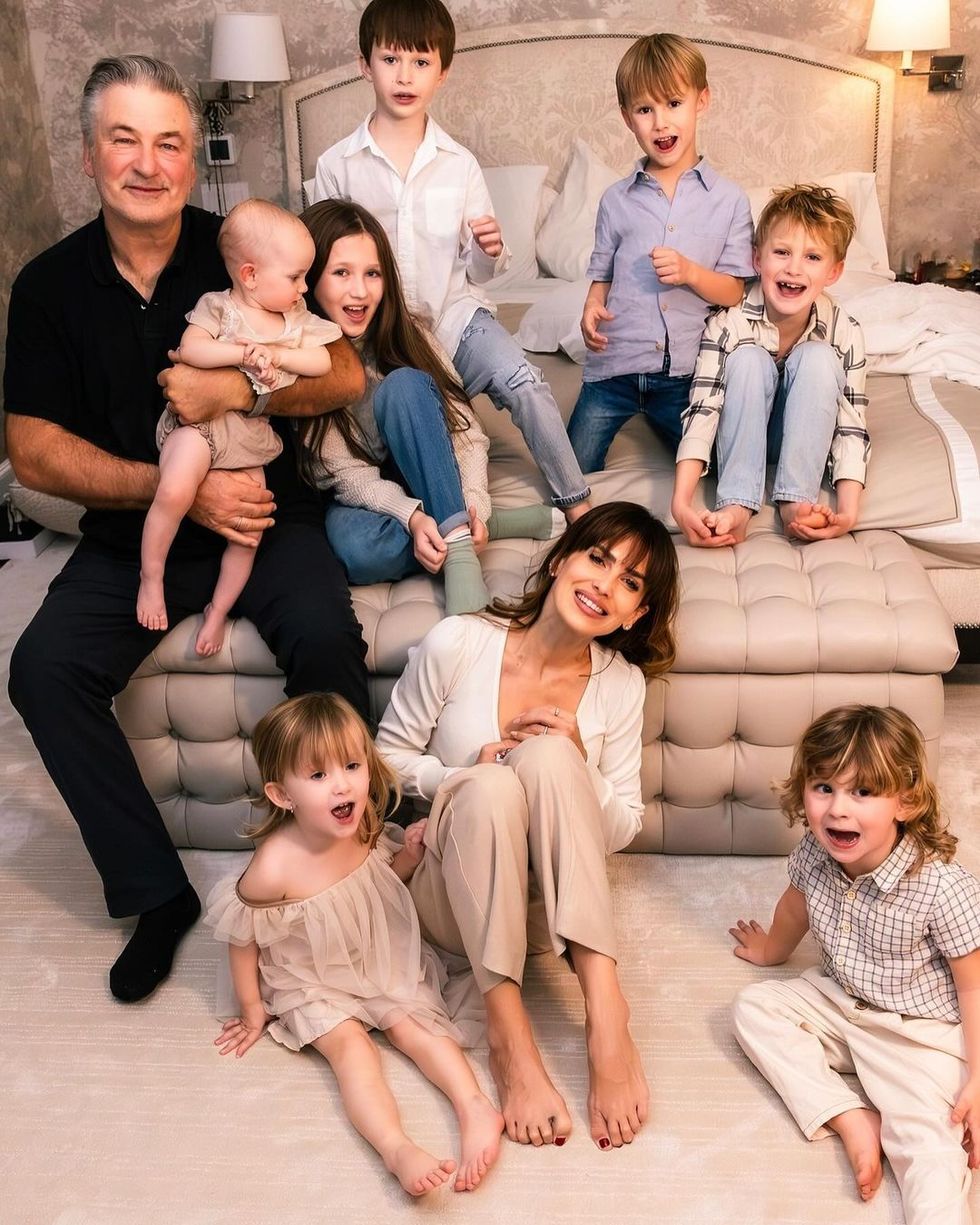 a group of people sitting on a couch, hilaria baldwin and alec baldwin with their children