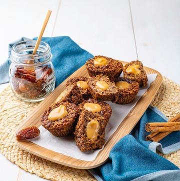 5 easy oat recipes perfect for the gym: Sticky date slice baked goods served on a wooden platter with a jar of dates