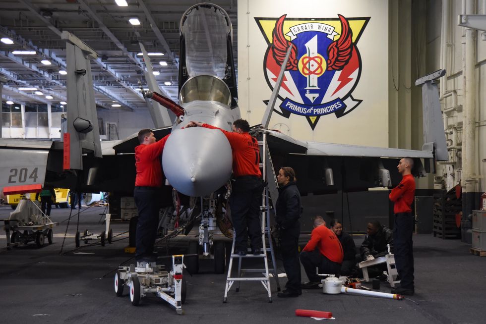 Sailors Conduct Maintenance On A F/A-18F Super Hornet