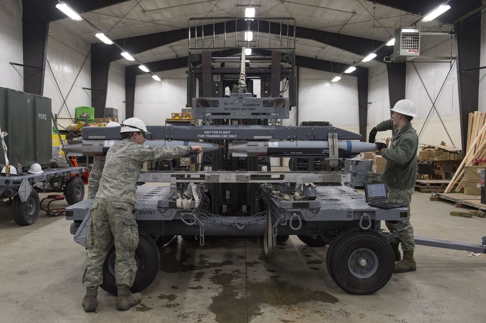 airmen with the 3rd munitions squadron transport a rack of inert small diameter bombs to a pallet during readiness training at joint base elmendorf richardson, alaska, feb 9, 2018 the small diameter bomb is a precise and accurate weapon that allows the f 22 raptor to deliver decisive air power us air force photo by alejandro peña