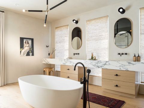 bathroom, wooden cabinets, white bathtubs, mirrors, ceiling light