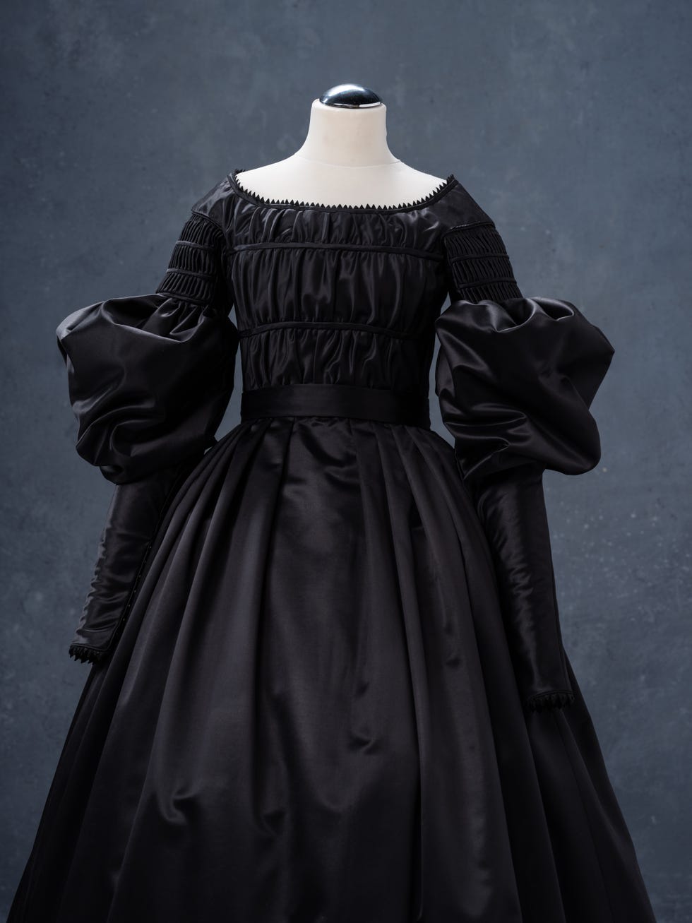 Elegant black gown with structured sleeves and a fitted bodice