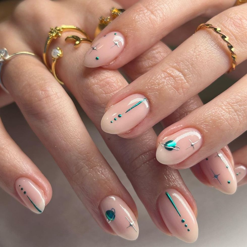 a woman's hand with painted fingernails