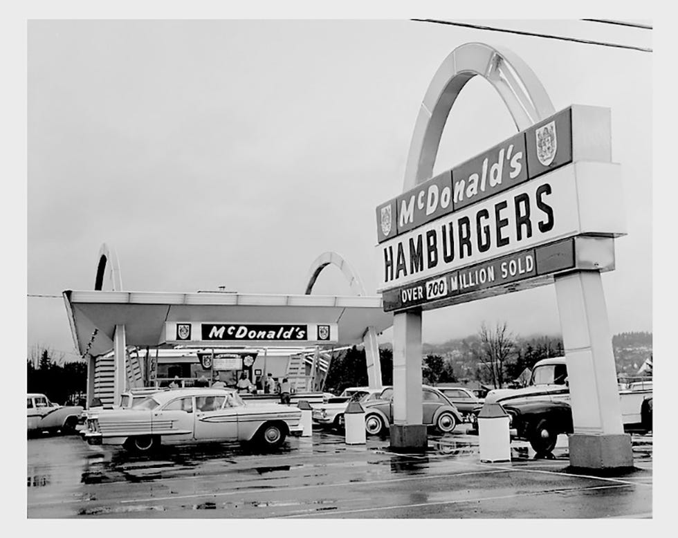 mcdonalds restaurant showcasing a vintage design with multiple cars in front