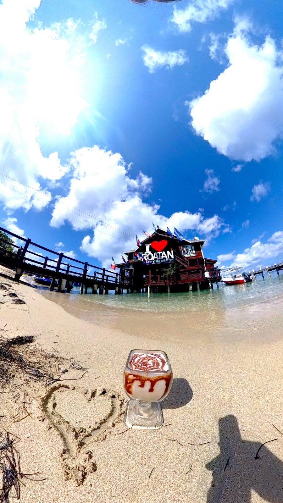 a glass of beer on a beach