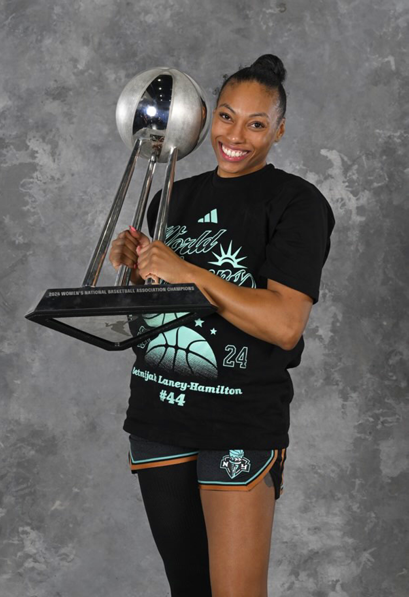 a basketball player holding a championship trophy