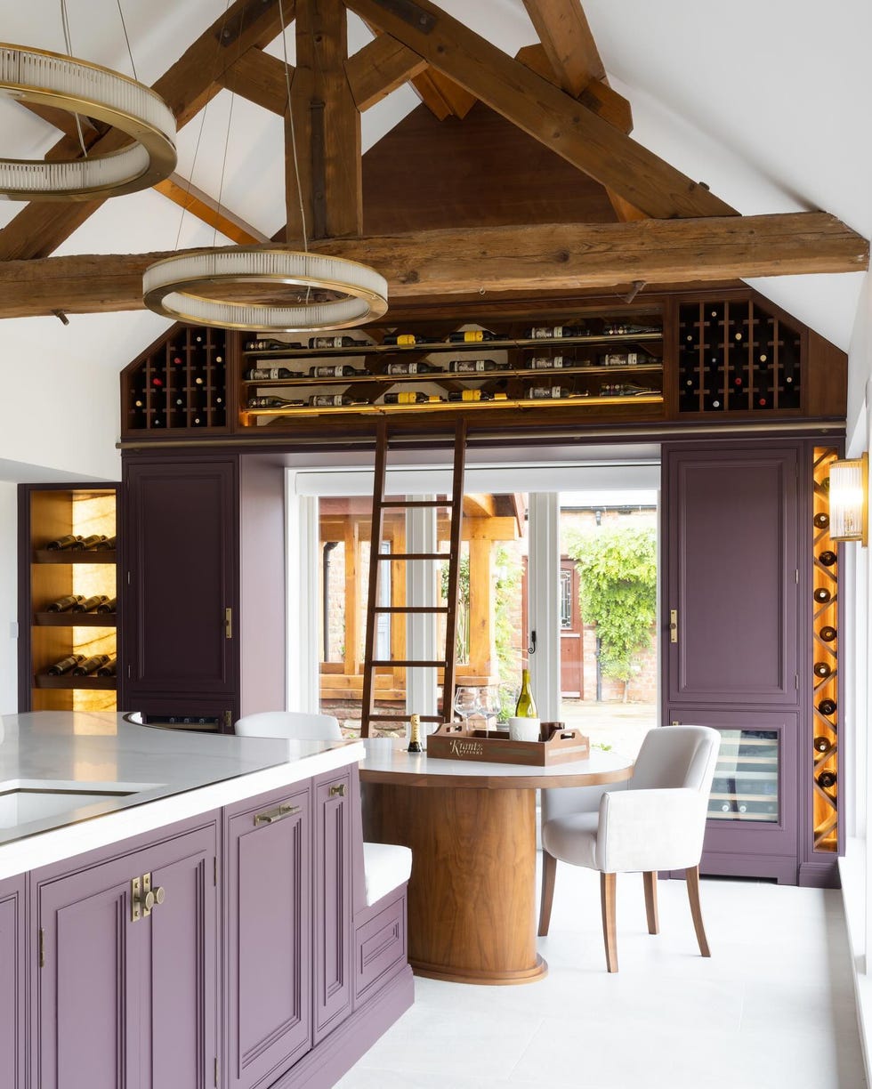 a kitchen with a bar and chairs a kitchen with a bar and chairs