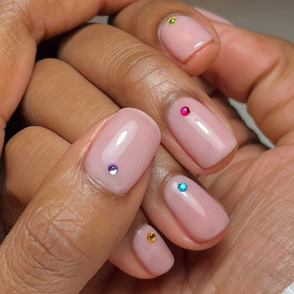a person's hand with painted fingernails