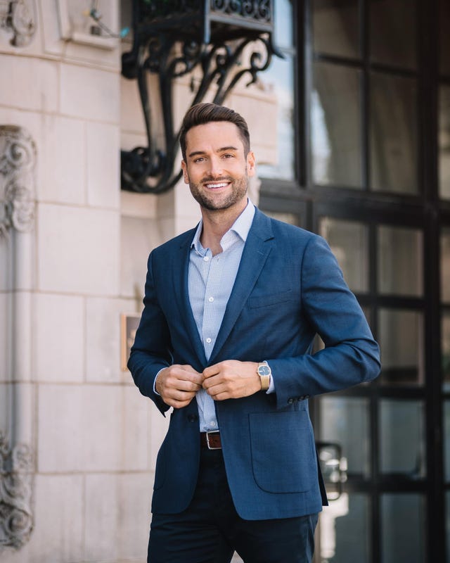 a person in a suit smiling