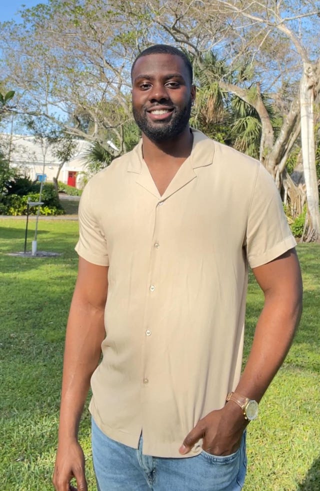 a man standing in a grassy area