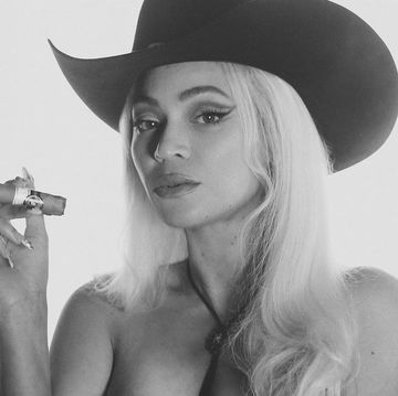 beyonce with a hat and a cigar