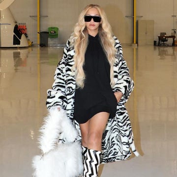beyonce n a fur coat and sunglasses in a warehouse