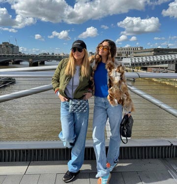 two women standing on a bridge