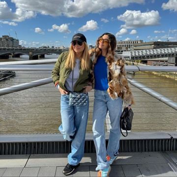 two women standing on a bridge