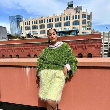 tracee ellis ross poses on a rooftop
