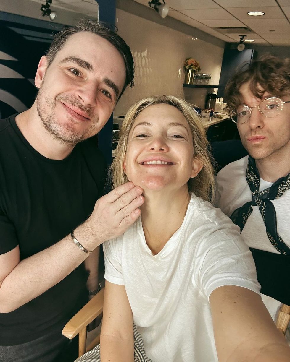 kate hudson smiles with her glam team wearing no makeup