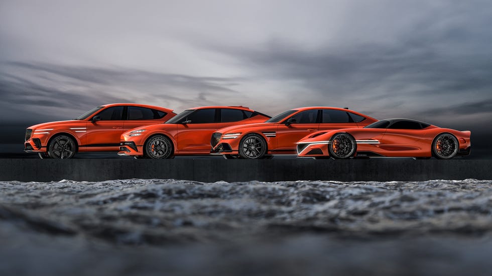 a couple of sports cars on a road with a cloudy sky