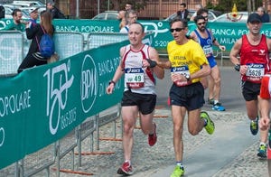 a group of people running on a road