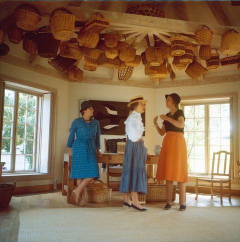 three women in room with baskets on ceiling