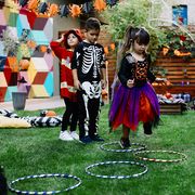 kids playing hopscotch game at halloween party