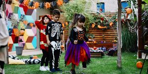 kids playing hopscotch game at halloween party