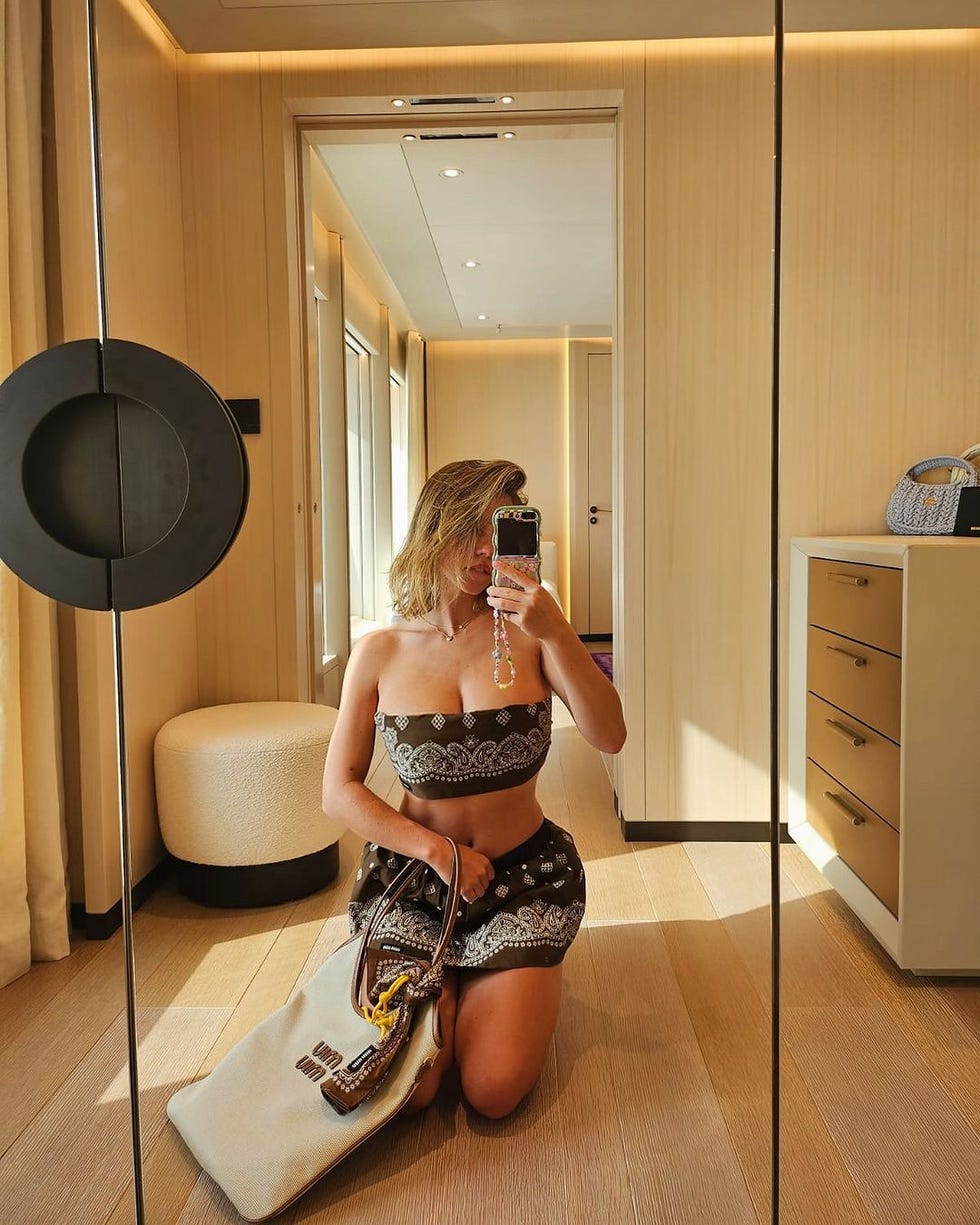 a woman taking a selfie in a mirror