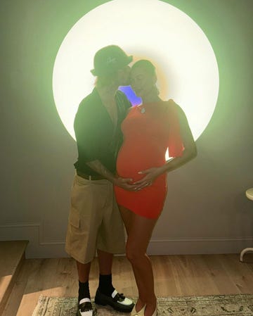 justin bieber kissing his pregnant wife hailey bieber in front of a james turrell art piece on august 3, 2024