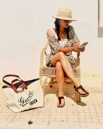 salma hayek poses in a brown and white gingham set while on vacation sitting next to a white gucci ibiza bag on august 15 2024