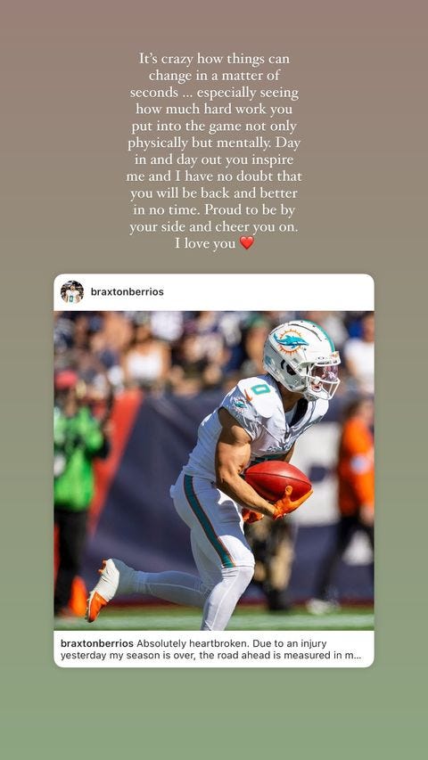 A football player in a Miami Dolphins uniform runs on the field during a game. The player is focused and moving. Some teammates and spectators can be seen in the background above the scene. There are words that express encouragement and support for a player who has faced an injury that highlights the emotional impact of the situation