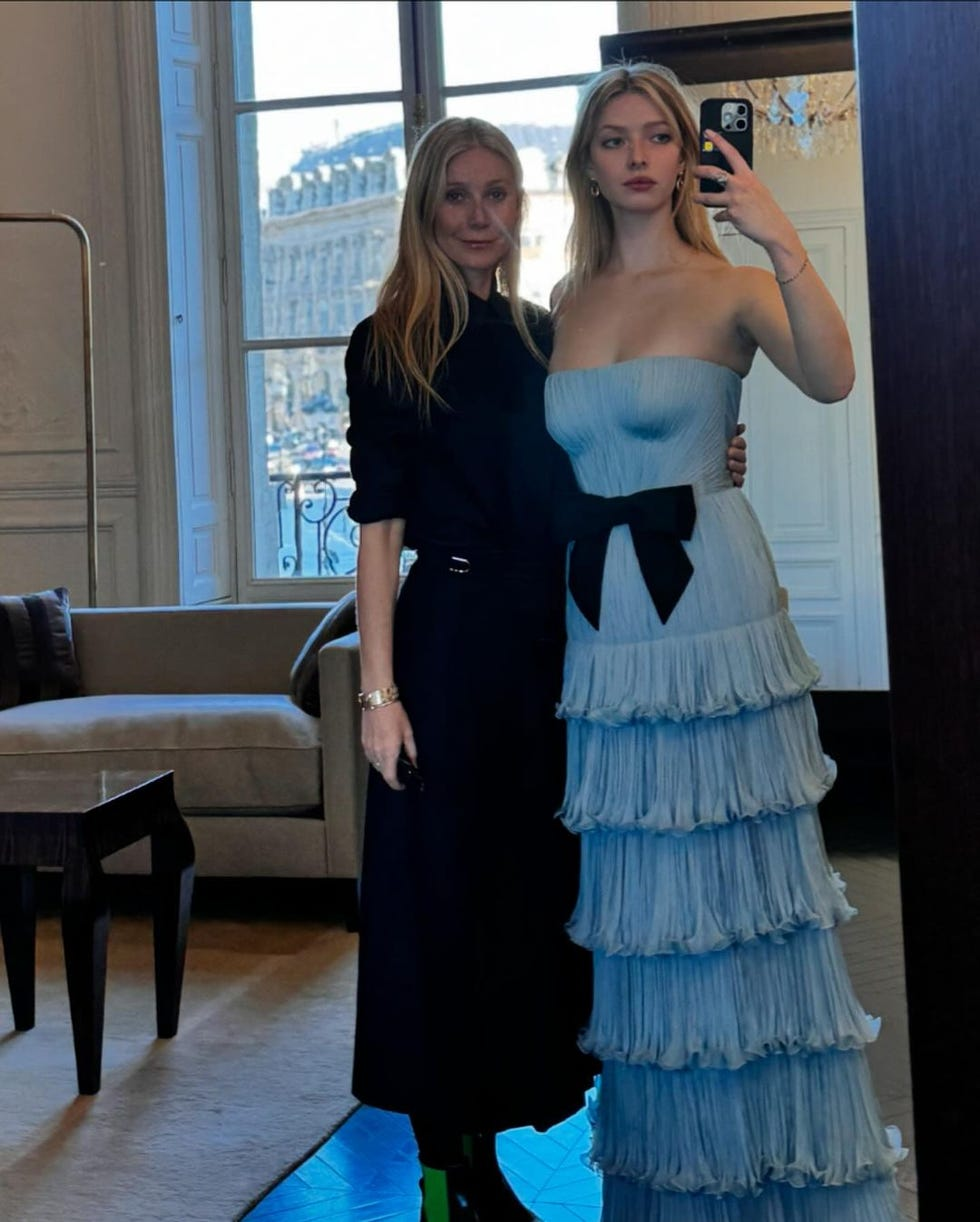 two women posing in a stylish indoor setting showcasing fashion