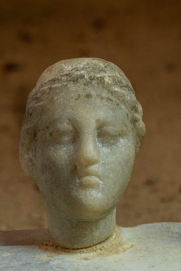 a sculptures head created from stone