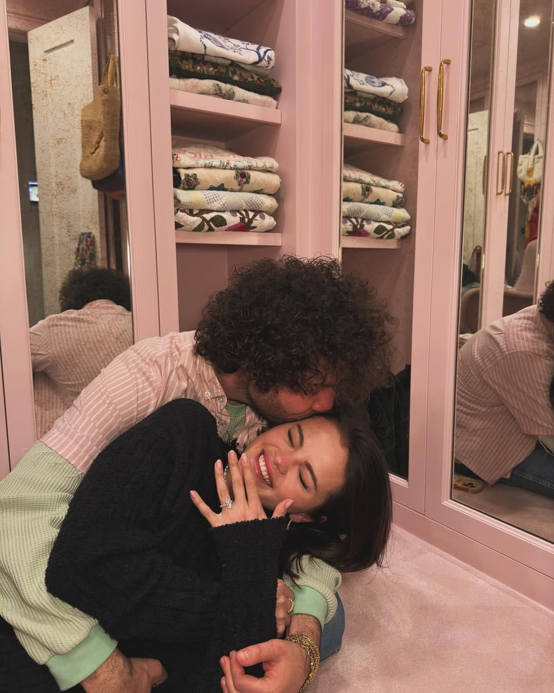 couple embracing in a cozy setting with reflected shelves in the background