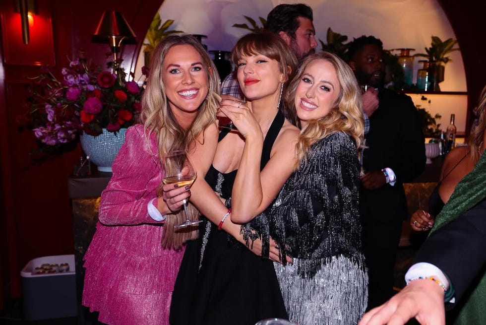 group of women socializing at a festive gathering with drinks in hand