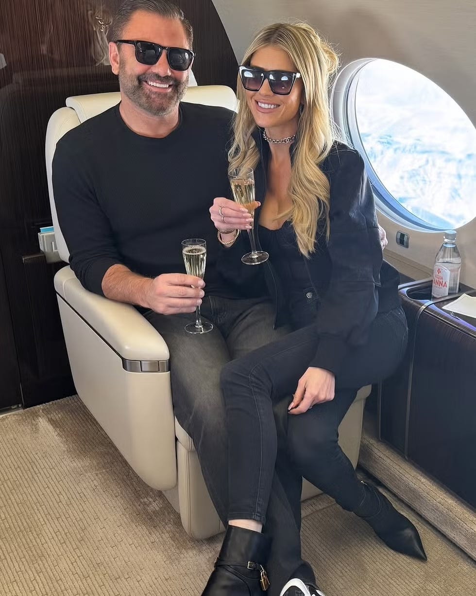 couple celebrating with champagne in a private jet