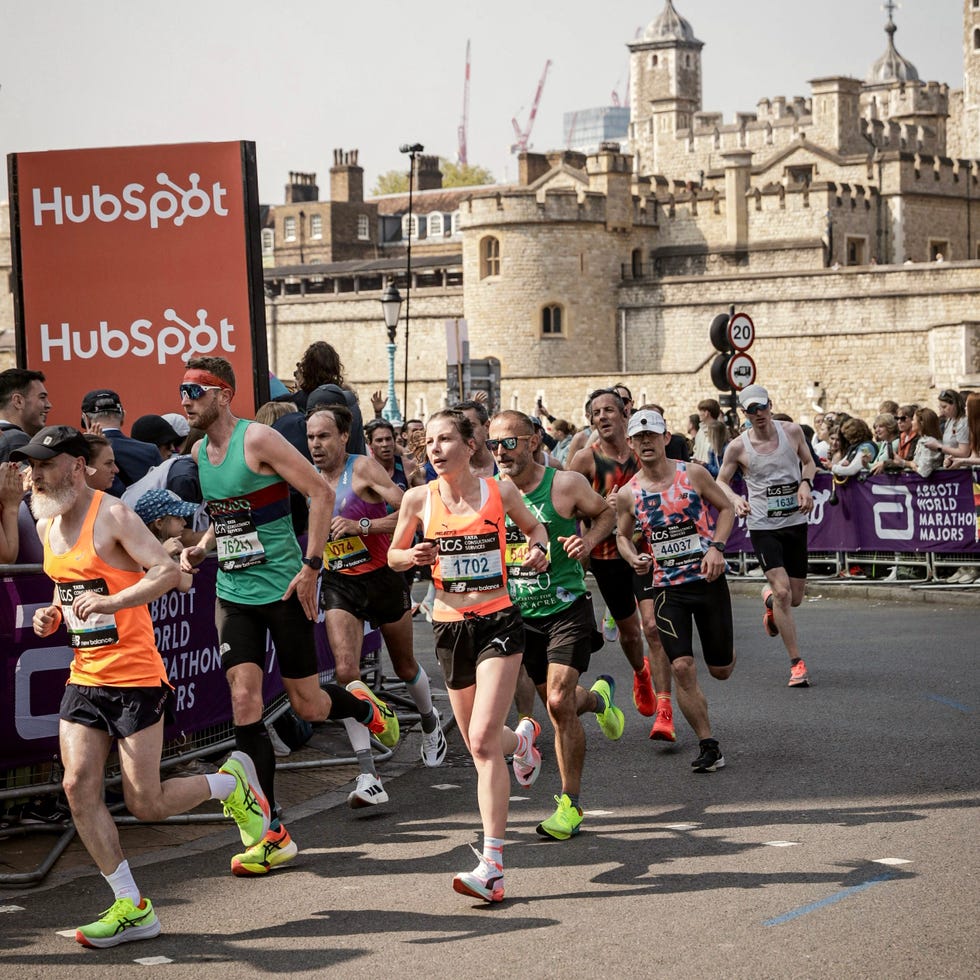 Runners participating in a marathon near a historic castle