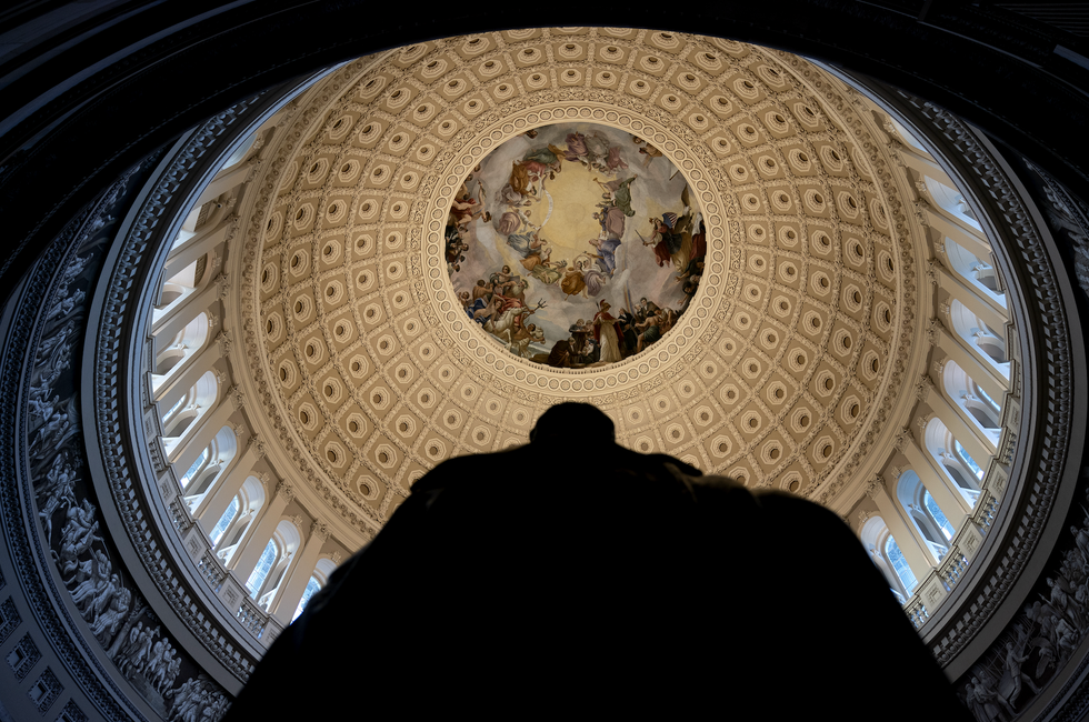 Interior view of a dome featuring artwork and intricate architectural details.