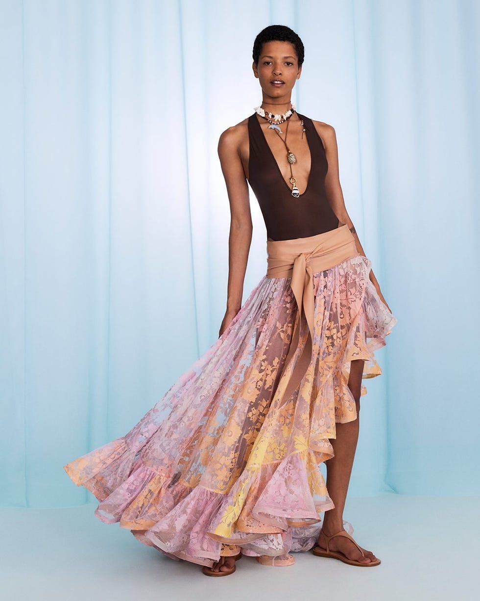 fashion model showcasing a vibrant outfit with unique fabric patterns and accessories