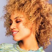 woman with 4a curly hair smiling