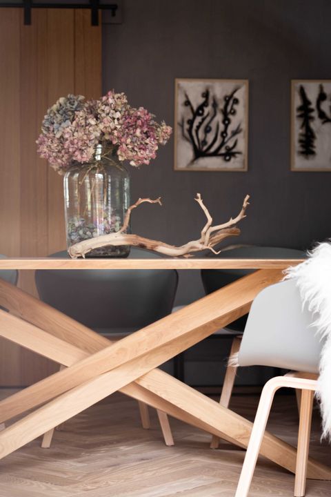 dining room, wooden dining table with wooden criss cross legs, blue chairs with sheep skin rugs