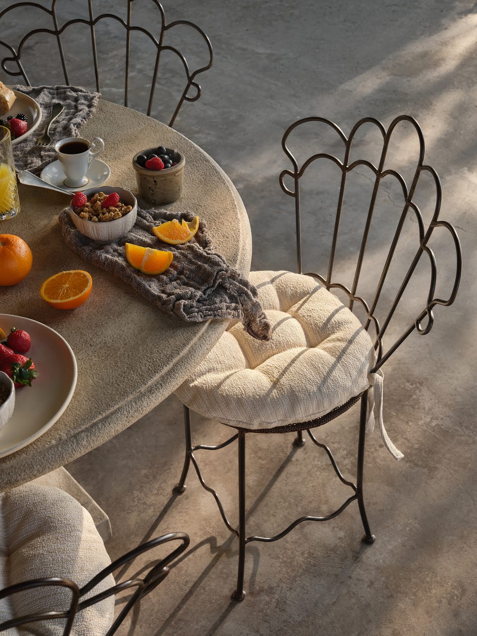 Dining setup with food, drinks, and unique chairs.