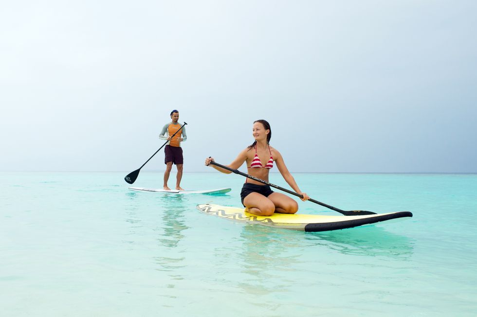 Stand up paddle surfing, Water transportation, Paddle, Surface water sports, Recreation, Fun, Vacation, Vehicle, Sports equipment, Water sport, 