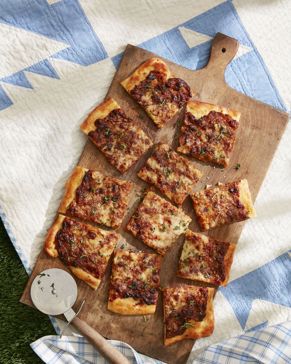 french onion flatbread on a wooden serving board and cut into squares for serving