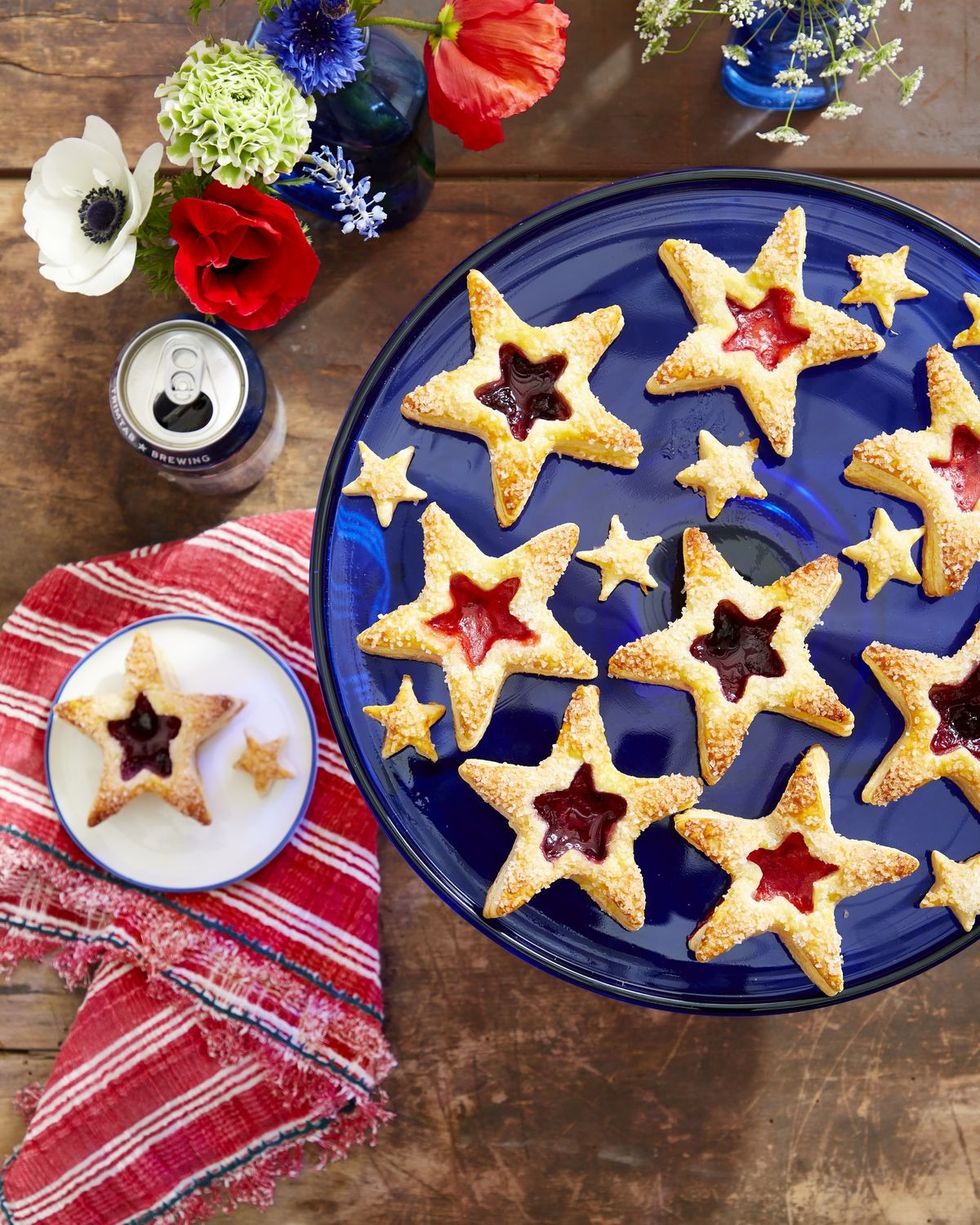 puff pastry star cookies with jam filled centers on a blue serving dish