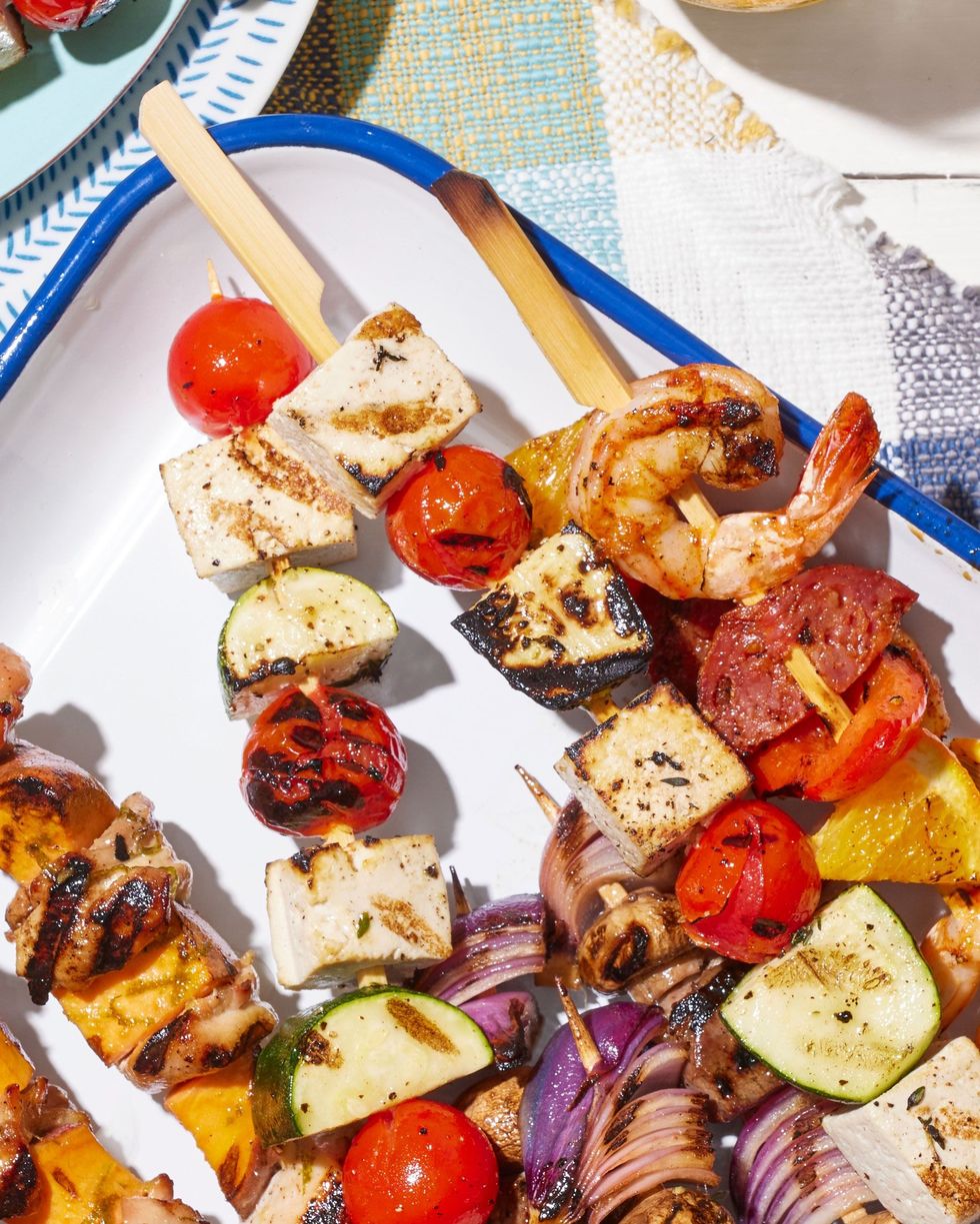 tofu tomato and zucchini kebabs on a white serving dish