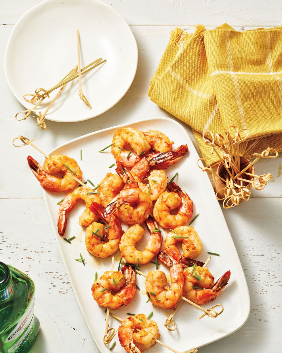 vermouth air fried shrimp on a white rectangular serving plate and on small wooden picks for serving