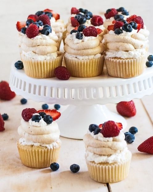 pavlova cupcakes with berries on cake stand