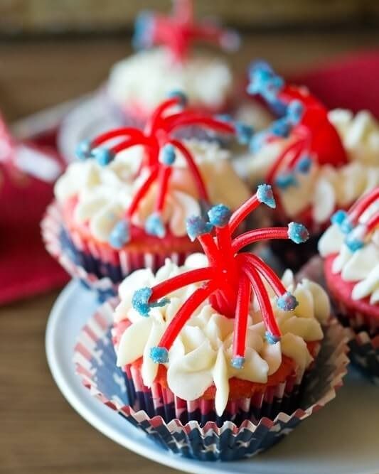 twizzler firecracker cupcakes with american flag cupcake wrappers on white cake stand