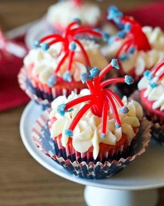 twizzler firecracker cupcakes with american flag cupcake wrappers on white cake stand