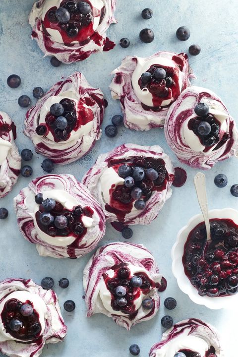 swirled meringues with blueberry sauce and fresh blueberries to garnish
